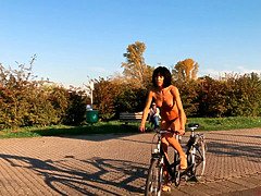 Beautiful naked girl rides a bicycle
