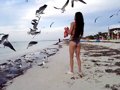 Petite chick gets naked and masturbates on the beach