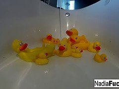 Nadia takes a bath with some rubber duckies